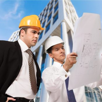 architect and supervisor Reviewing Blueprints