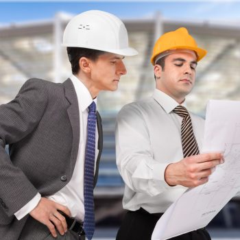architect and supervisor Reviewing Blueprints