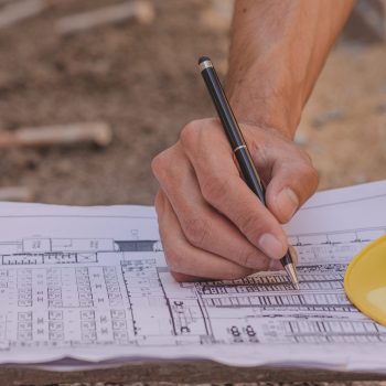 Hand writing on blueprint planing to building construction development